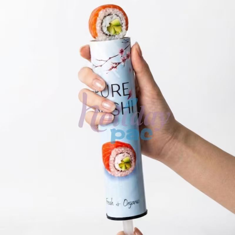 Holidaypac custom sushi push pop tube held in hand with sushi roll