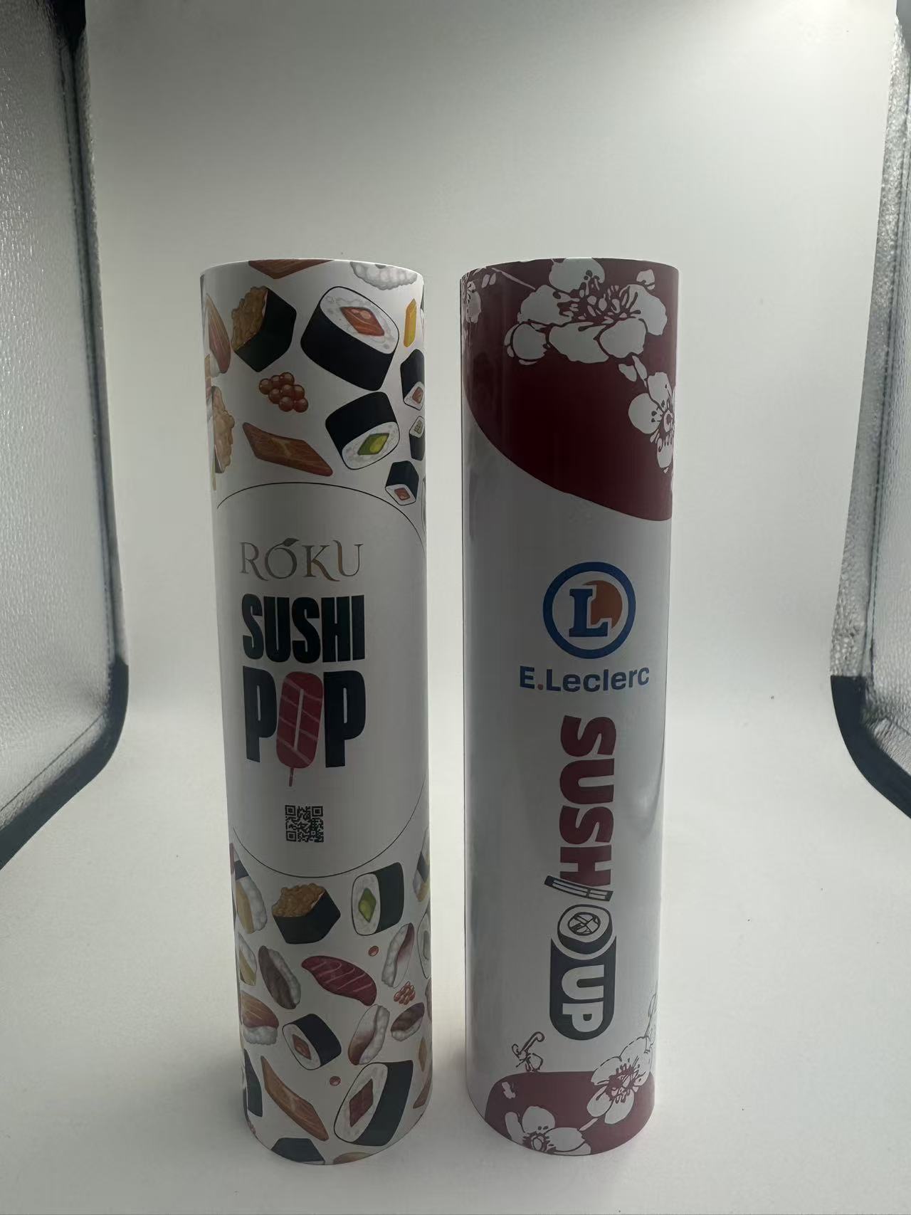 Two custom printed sushi packaging tube samples