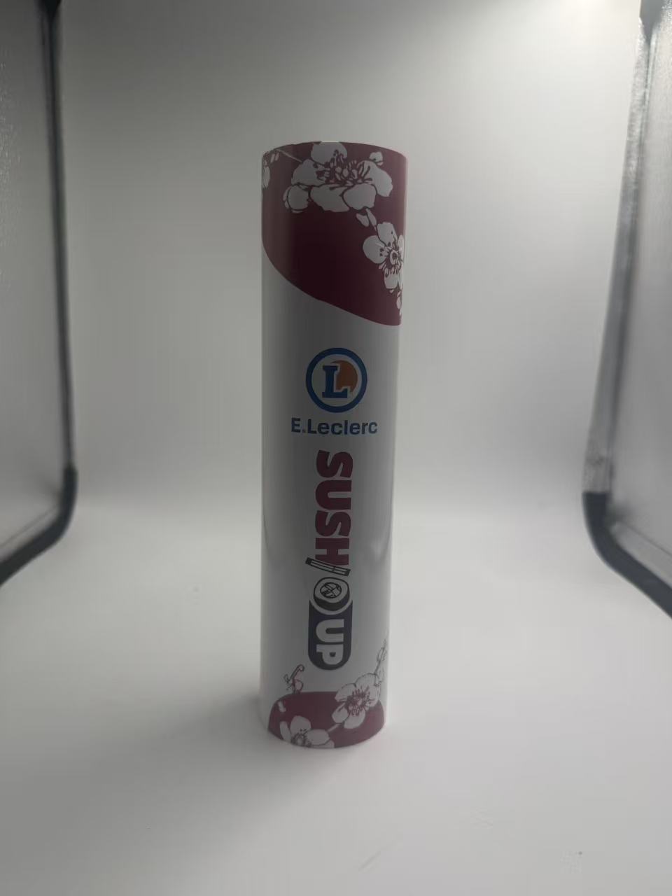 Sushi Packaging: Custom Printed Push Pop Tube Design Guide 3 White sushi tube sample with burgundy blossom artwork and vertical wording