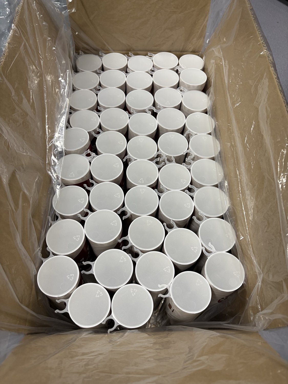 Custom Sushi Push Pop Tube Lids: Our Own Mold and Packaging Development 1 White molded sushi tube lids with side holder features arranged in a lined carton
